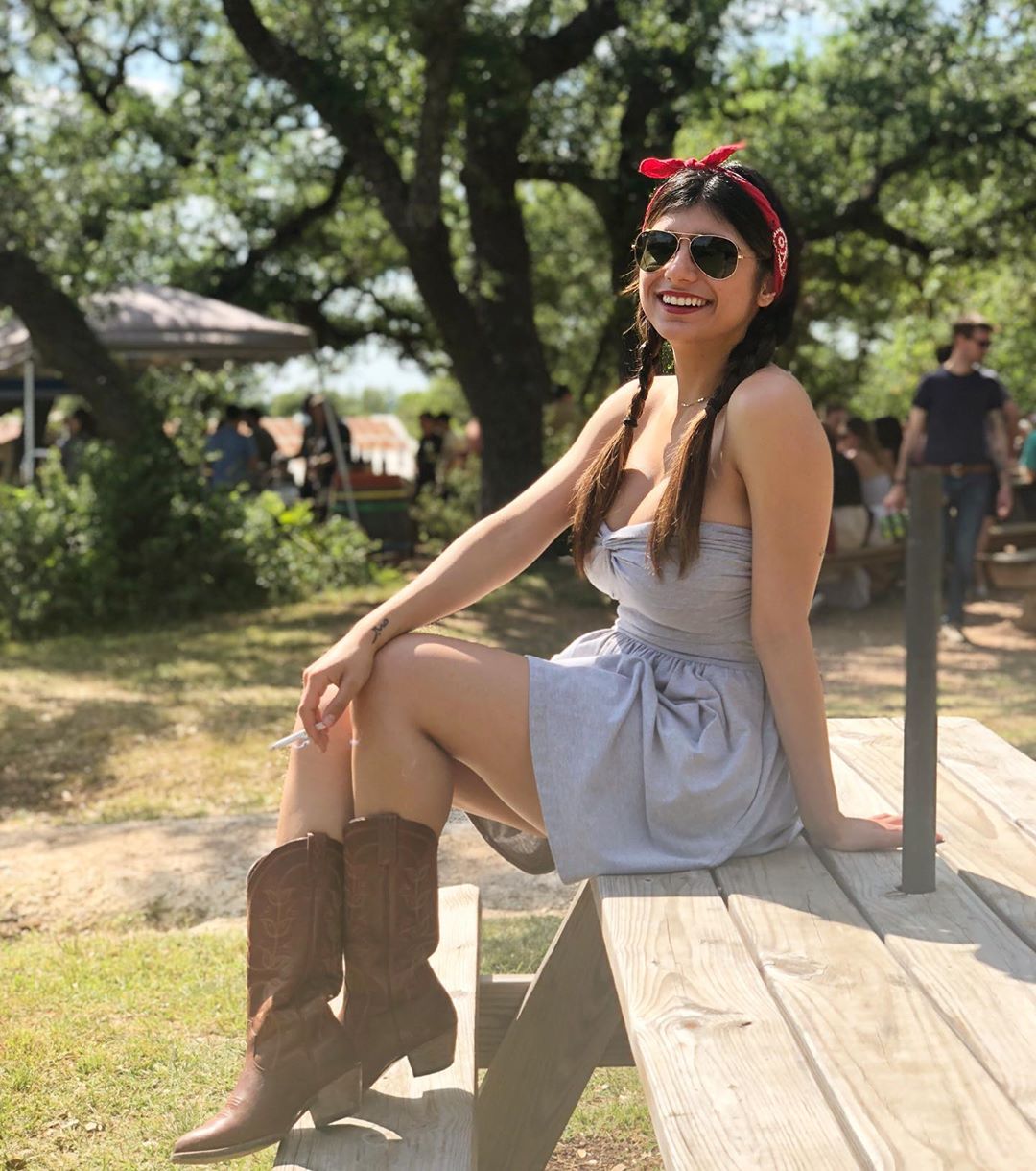Hot Mia Khalifa sitting in the park wearing sungalsses and enjoying the weather