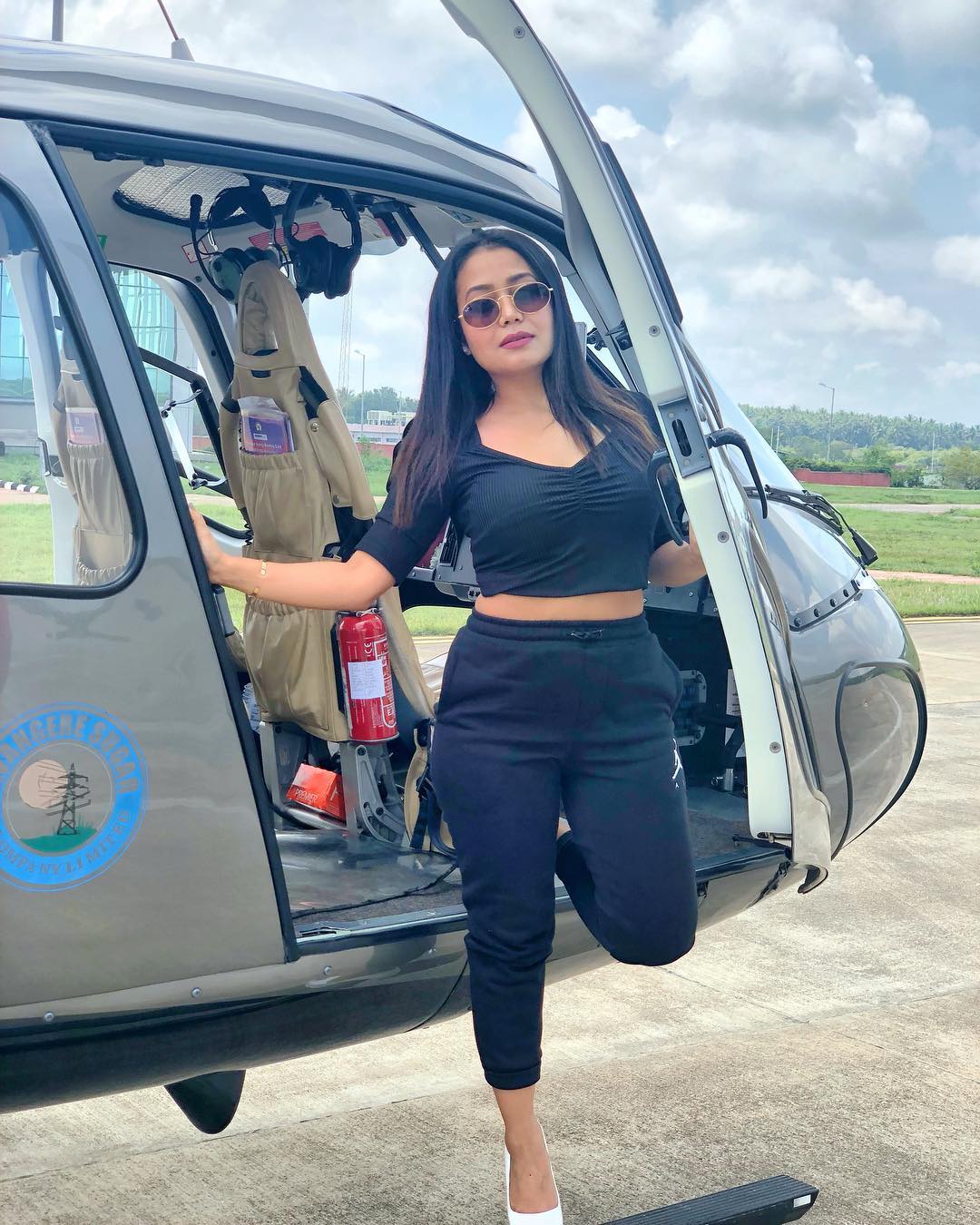 neha kakkar in black in a helicopter