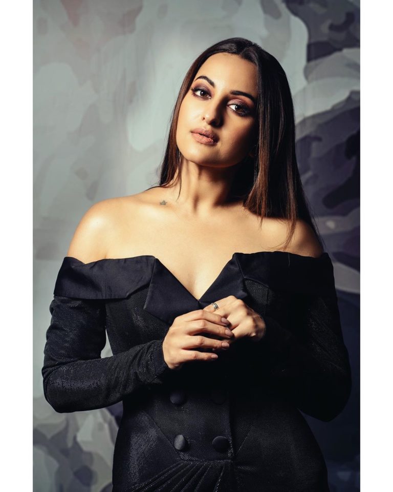 Bollywood actress sonakshi sinha wearing a black revealing top dress