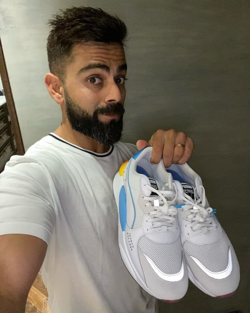 indian cricketer virat kohli showing his puma sports shoes