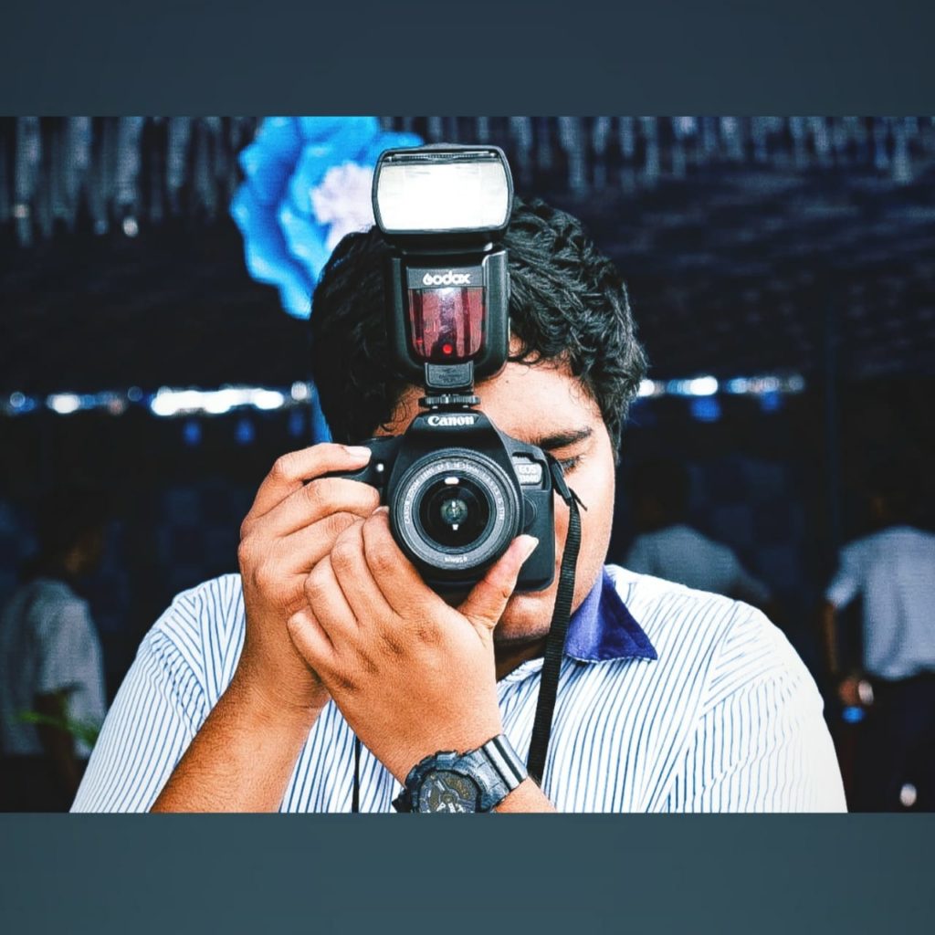 Shannon Desmond Alvares with camera at a function at his Higher Seconday School